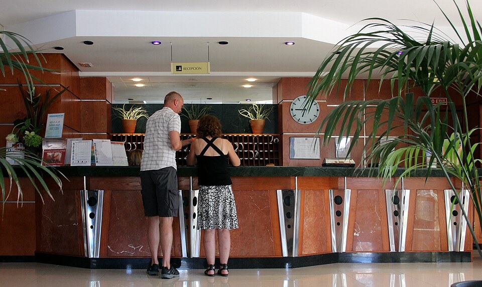 Guests at a hotel reception desk